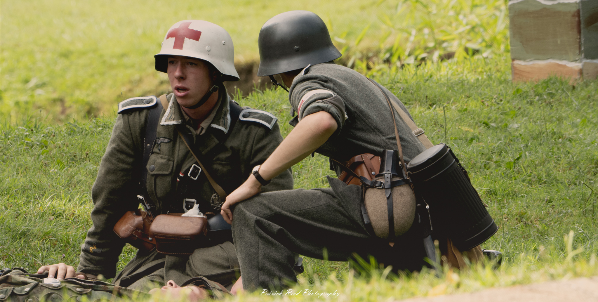 A medic kneeling in a field with a stunned expression, surrounded by the aftermath of battle. His eyes reflect shock and disbelief as he assesses the situation, embodying the emotional toll of providing care in such a chaotic environment.
